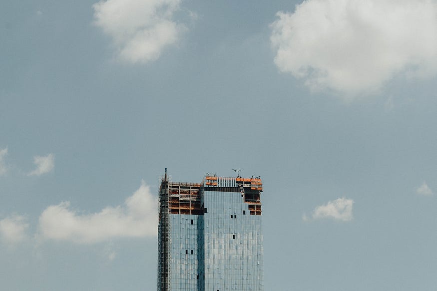 An unfinished building under a blue sky.